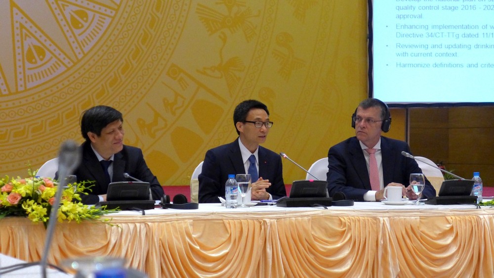 Australian Ambassador and Deputy PM Vu Duc Dam at a conference in Ha Noi